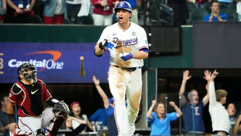 Oct 27, 2023; Arlington, Texas, USA; Texas Rangers Corey Seager (5) hits a two-run home run off Arizona Diamondbacks relief pitcher Paul Sewald (38) in the ninth inning during Game 1 of 2023 World Series at Globe Life Field. Mandatory Credit: Rob Schumacher-Arizona Republic