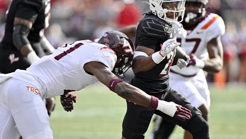 Nov 4, 2023; Louisville, Kentucky, USA;  Louisville Cardinals running back Jawhar Jordan (25) runs the ball against Virginia Tech Hokies linebacker Keli Lawson (21) during the first quarter at L&N Federal Credit Union Stadium. Mandatory Credit: Jamie Rhodes-USA TODAY Sports