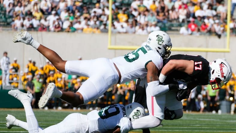 Nov 4, 2023; Waco, Texas, USA;  Houston Cougars tight end Mike O'Laughlin (17) makes a catch against Baylor Bears cornerback Caden Jenkins (19) and linebacker Garmon Randolph (55) during the first half at McLane Stadium. Mandatory Credit: Chris Jones-USA TODAY Sports