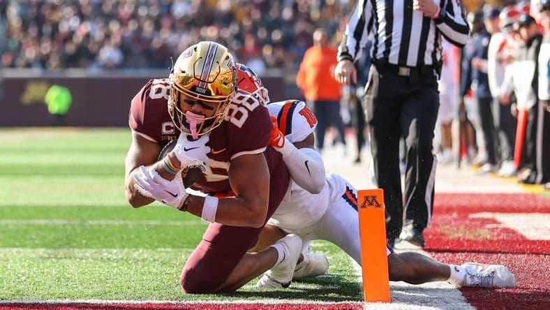 Nov 4, 2023; Minneapolis, Minnesota, USA; Minnesota Golden Gophers tight end Brevyn Spann-Ford (88) dives for a touchdown while Illinois Fighting Illini defensive back Miles Scott (10) defends during the first half at Huntington Bank Stadium. Mandatory Credit: Matt Krohn-USA TODAY Sports