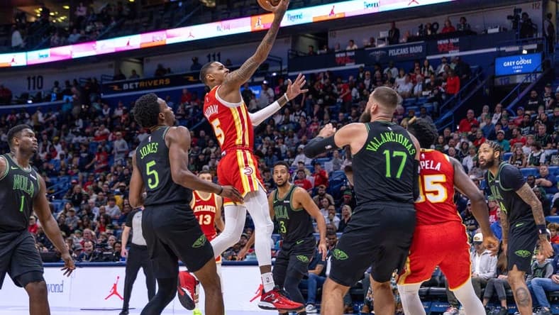 Nov 4, 2023; New Orleans, Louisiana, USA;  Atlanta Hawks guard Dejounte Murray (5) drives to the basket against New Orleans Pelicans forward Herbert Jones (5) during the first half at Smoothie King Center. Mandatory Credit: Stephen Lew-USA TODAY Sports