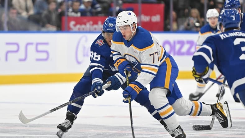Nov 4, 2023; Toronto, Ontario, CAN; lBuffalo Sabres forward JJ Peterka (77) skates with the puck past Toronto Maple Leafs forward William Nylander (88) in the second period at Scotiabank Arena. Mandatory Credit: Dan Hamilton-USA TODAY Sports