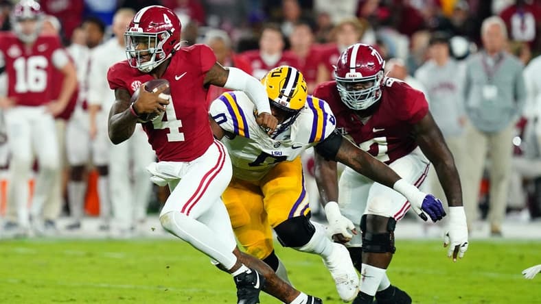Nov 4, 2023; Tuscaloosa, Alabama, USA; Alabama Crimson Tide quarterback Jalen Milroe (4) scrambles up the field against the LSU Tigers during the second quarter at Bryant-Denny Stadium. Mandatory Credit: John David Mercer-USA TODAY Sports