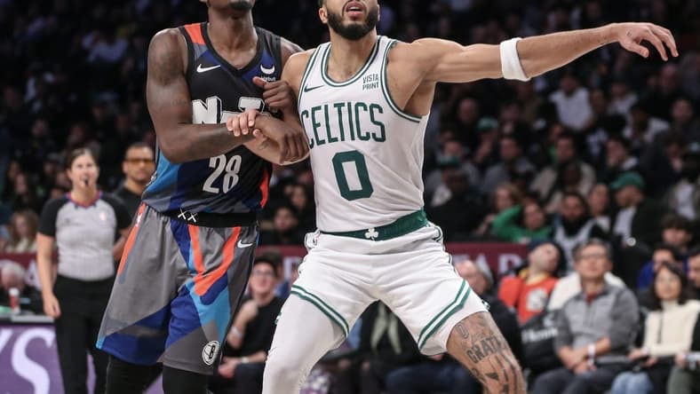 Nov 4, 2023; Brooklyn, New York, USA;  Brooklyn Nets forward Dorian Finney-Smith (28) and Boston Celtics forward Jayson Tatum (0) box out for a rebound in the fourth quarter at Barclays Center. Mandatory Credit: Wendell Cruz-USA TODAY Sports