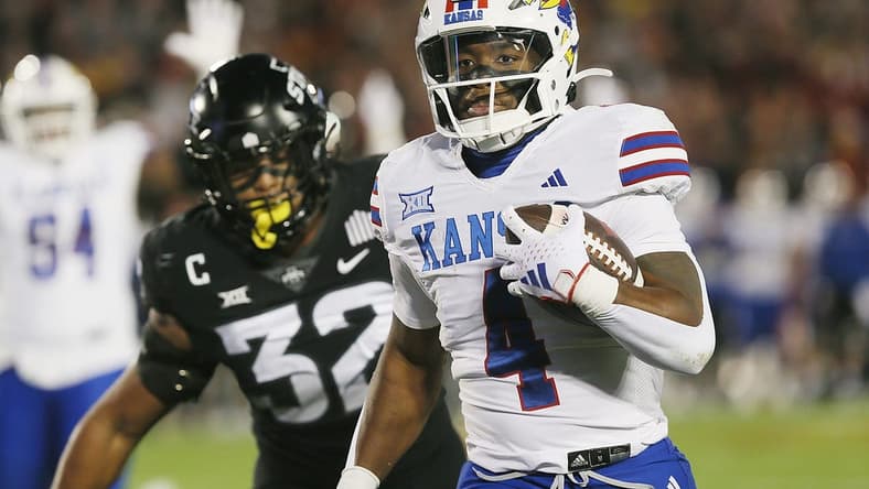 Kansas Jayhawks running back Devin Neal (4) runs for a touchdown against Iowa State during the first quarter at Jack Trice Stadium on Saturday, Nov. 4, 2023, in Ames, Iowa.