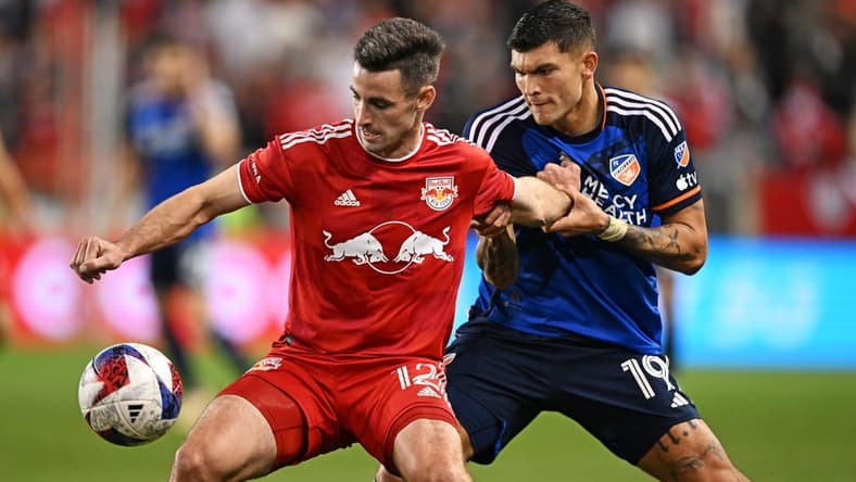 Nov 4, 2023; Harrison, NJ, USA; New York Red Bulls defender Dylan Nealis (12) and FC Cincinnati forward Brandon V zquez (19) battle for the ball during the second half of game two in a round one match of the 2023 MLS Cup Playoffs at Red Bull Arena. Mandatory Credit: Mark Smith-USA TODAY Sports