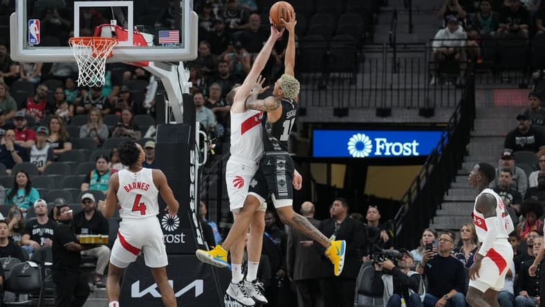 Nov 5, 2023; San Antonio, Texas, USA; Toronto Raptors center Jakob Poeltl (19) blocks a shot by San Antonio Spurs forward Jeremy Sochan (10) in the first half at the Frost Bank Center. Mandatory Credit: Daniel Dunn-USA TODAY Sports