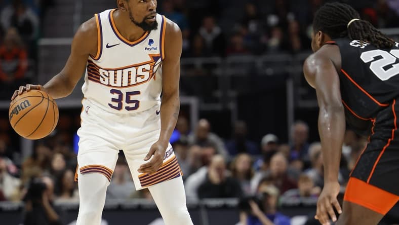 Nov 5, 2023; Detroit, Michigan, USA;  Phoenix Suns forward Kevin Durant (35) dribbles defended by Detroit Pistons center Isaiah Stewart (28) in the first half at Little Caesars Arena. Mandatory Credit: Rick Osentoski-USA TODAY Sports
