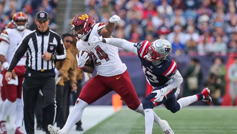 Nov 5, 2023; Foxborough, Massachusetts, USA; New England Patriots cornerback Jack Jones (13) pushes Washington Commanders running back Antonio Gibson (24) out of bounds during the second half at Gillette Stadium. Mandatory Credit: Paul Rutherford-USA TODAY Sports