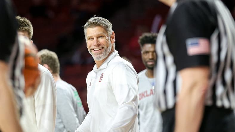 Oklahoma head coach Porter Moser smiles at referees in the second half during a basketball game between The Oklahoma Sooners (OU) and Kansas State Wildcats at the Lloyd Noble Center in Norman, Okla., Tuesday, Feb. 14, 2023.