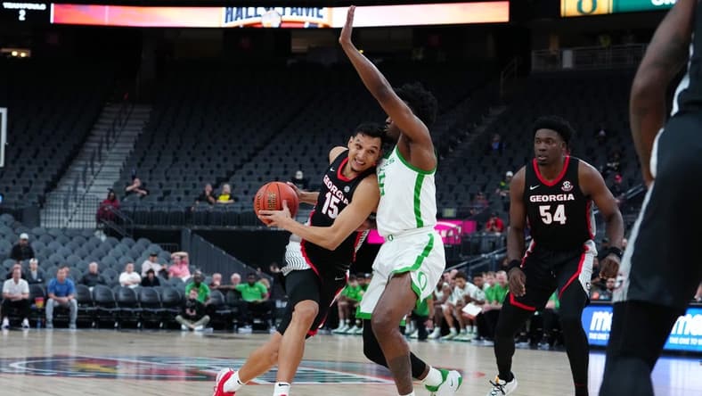 Nov 6, 2023; Las Vegas, Nevada, USA; Georgia Bulldogs guard RJ Melendez (15) drives against Oregon Ducks guard Jermaine Couisnard (5) during the second half at T-Mobile Arena. Mandatory Credit: Stephen R. Sylvanie-USA TODAY Sports