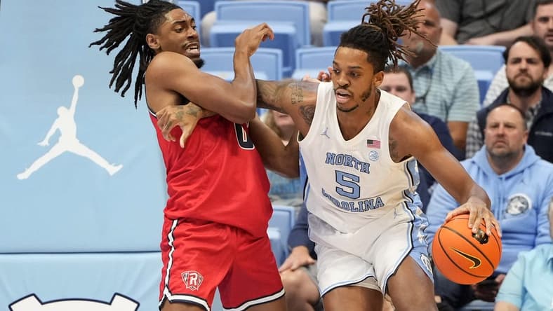 Nov 6, 2023; Chapel Hill, North Carolina, USA;  North Carolina Tar Heels forward Armando Bacot (5) with the ball as Radford Highlanders forward Justin Archer (0) defends in the first half at Dean E. Smith Center. Mandatory Credit: Bob Donnan-USA TODAY Sports