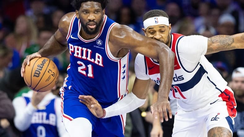 Nov 6, 2023; Philadelphia, Pennsylvania, USA; Philadelphia 76ers center Joel Embiid (21) collides with Washington Wizards forward Daniel Gafford (21) while bringing the ball up court during the first quarter at Wells Fargo Center. Mandatory Credit: Bill Streicher-USA TODAY Sports