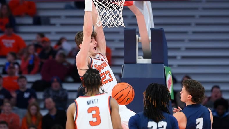 Nov 6, 2023; Syracuse, New York, USA; Syracuse Orange center Peter Carey (23) reacts to his dunk against the New Hampshire Wildcats during the first half at the JMA Wireless Dome. Mandatory Credit: Rich Barnes-USA TODAY Sports