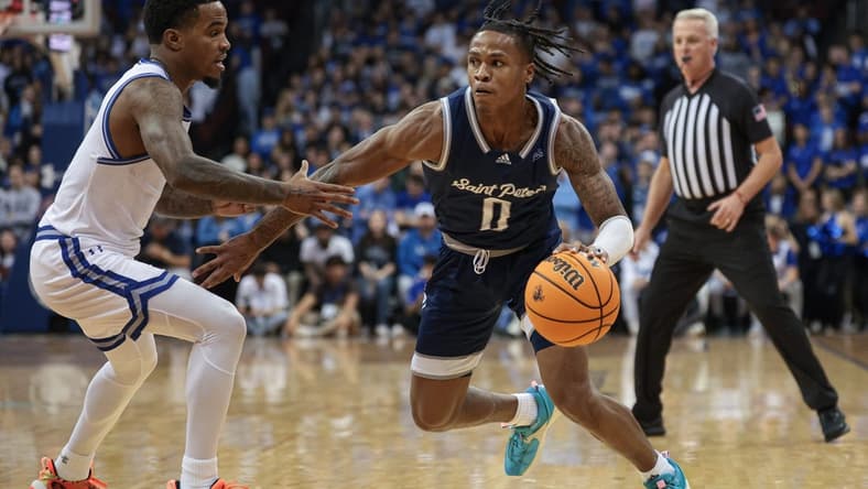 Nov 6, 2023; Newark, New Jersey, USA; St. Peter's Peacocks guard Latrell Reid (0) dribbles against Seton Hall Pirates guard Al-Amir Dawes (2) during the first half at Prudential Center. Mandatory Credit: Vincent Carchietta-USA TODAY Sports