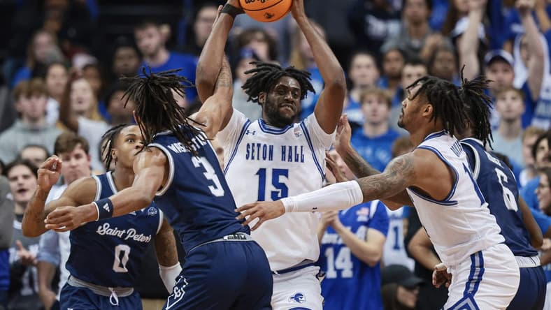 Nov 6, 2023; Newark, New Jersey, USA; Seton Hall Pirates center Jaden Bediako (15) rebounds against St. Peter's Peacocks forward Corey Washington (3) during the first half at Prudential Center. Mandatory Credit: Vincent Carchietta-USA TODAY Sports