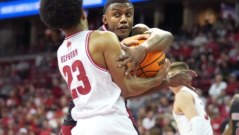 Nov 6, 2023; Madison, Wisconsin, USA;  Wisconsin Badgers guard Chucky Hepburn (23) forces a jump ball with Arkansas State Red Wolves guard Derrian Ford (3) during the first half at the Kohl Center. Mandatory Credit: Kayla Wolf-USA TODAY Sports
