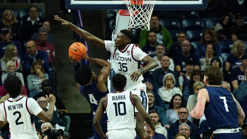 Nov 6, 2023; Storrs, Connecticut, USA; UConn Huskies forward Samson Johnson (35) defends against Northern Arizona Lumberjacks guard Oakland Fort (4) in the first half at Harry A. Gampel Pavilion. Mandatory Credit: David Butler II-USA TODAY Sports