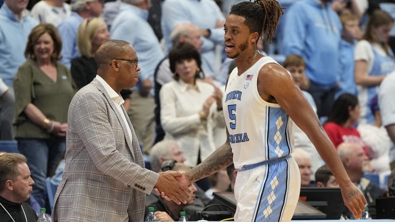 Nov 6, 2023; Chapel Hill, North Carolina, USA; North Carolina Tar Heels forward Armando Bacot (5) shakes hands with head coach Hubert Davis leaving the court in the second half at Dean E. Smith Center. Mandatory Credit: Bob Donnan-USA TODAY Sports