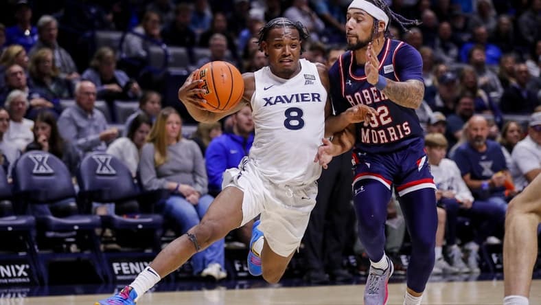 Nov 6, 2023; Cincinnati, Ohio, USA; Xavier Musketeers guard Quincy Olivari (8) drives to the basket against Robert Morris Colonials guard Josh Corbin (32) in the first half at Cintas Center. Mandatory Credit: Katie Stratman-USA TODAY Sports