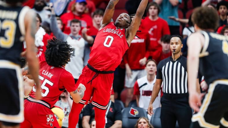 Louisville Cardinals guard Mike James (0) grabs a rebound Monday night. James had a25 points and 10 rebounds as the Cards beat UMBC 94-93. Nov.6, 2023.
