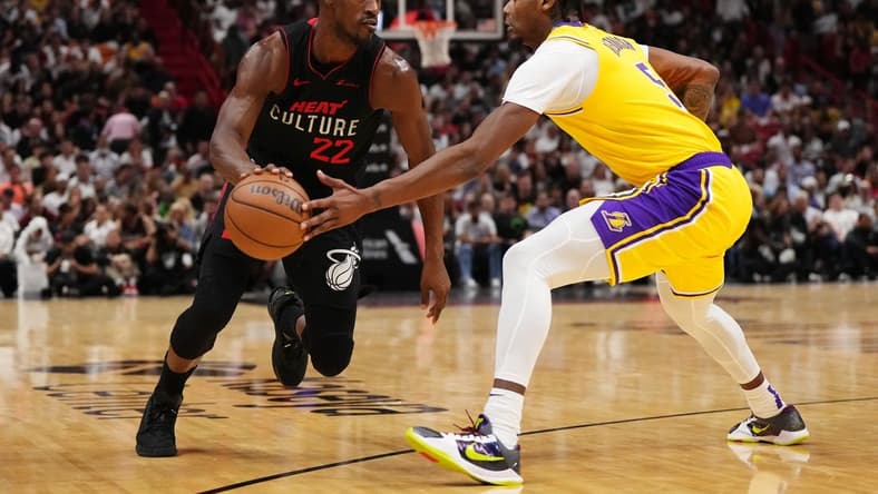 Nov 6, 2023; Miami, Florida, USA; Miami Heat forward Jimmy Butler (22) drives the ball around Los Angeles Lakers forward Cam Reddish (5) during the first half at Kaseya Center. Mandatory Credit: Jasen Vinlove-USA TODAY Sports