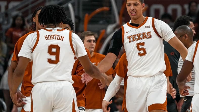 Texas Longhorns forward Kadin Shedrick (5) celebrates with guard Ithiel Horton (9) during a timeout in the men   s basketball game against the University of the Incarnate Word at the Moody Center on Monday, Nov. 6, 2023 in Austin.