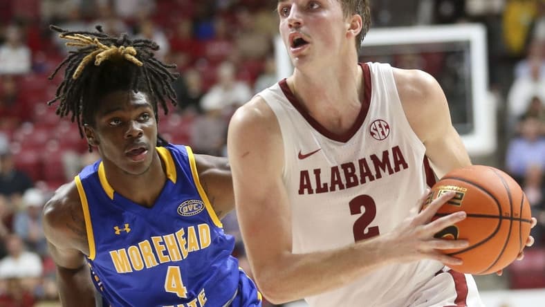 Nov 6, 2023; Tuscaloosa, Alabama, USA; Alabama forward Grant Nelson (2) drives past Morehead State guard Eddie Ricks (4) on his way to the hoop in the game at Coleman Coliseum. Mandatory Credit: Gary Cosby Jr.-USA TODAY Sports