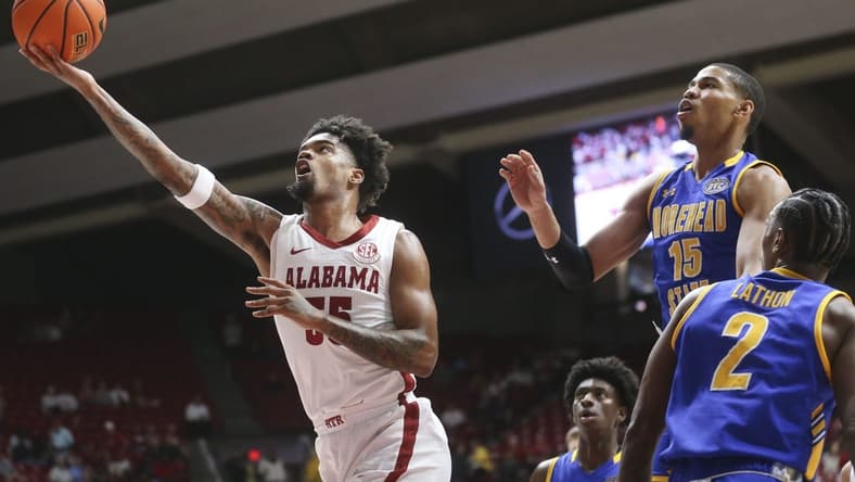 Nov 6, 2023; Tuscaloosa, Alabama, USA;  Alabama guard Aaron Estrada drives and scores past Morehead State guard Kalil Thomas (15) and Morehead State guard Jordan Lathon (2) in the game at Coleman Coliseum. Mandatory Credit: Gary Cosby Jr.-USA TODAY Sports