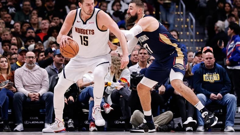 Nov 6, 2023; Denver, Colorado, USA; Denver Nuggets center Nikola Jokic (15) controls the ball as New Orleans Pelicans center Jonas Valanciunas (17) guards in the second quarter at Ball Arena. Mandatory Credit: Isaiah J. Downing-USA TODAY Sports