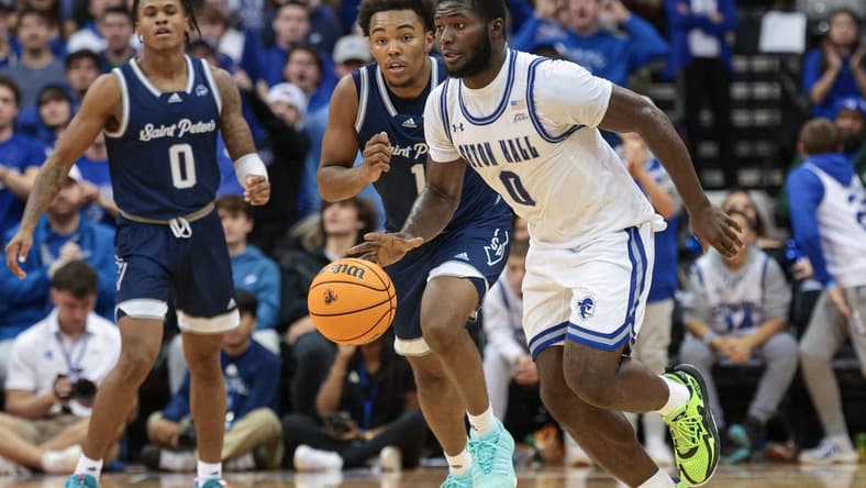 Nov 6, 2023; Newark, New Jersey, USA; Seton Hall Pirates guard Dylan Addae-Wusu (0) dribbles in front of St. Peter's Peacocks guard Brent Bland (1) and guard Latrell Reid (0) during the second half at Prudential Center. Mandatory Credit: Vincent Carchietta-USA TODAY Sports