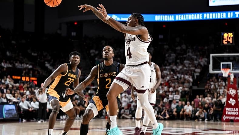 Nov 6, 2023; College Station, Texas, USA; Texas A&M Aggies guard Wade Taylor IV (4) passes the ball as Texas A&M Commerce guard Kalen Williams (2) defends during the second half at Reed Arena. Mandatory Credit: Maria Lysaker-USA TODAY Sports