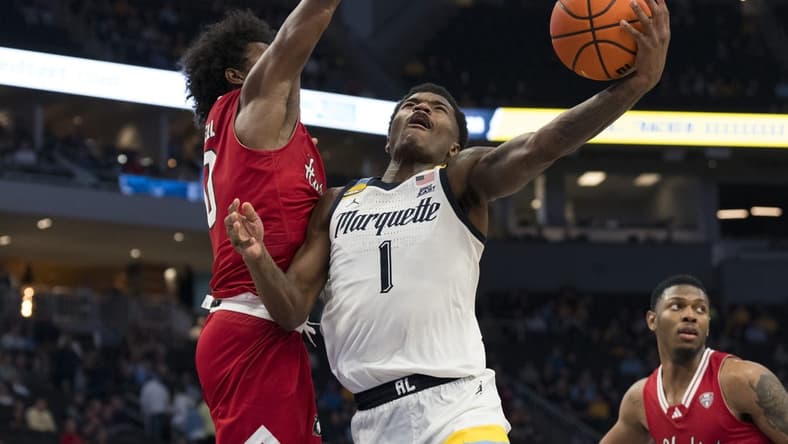 Nov 6, 2023; Milwaukee, Wisconsin, USA;  Marquette Golden Eagles guard Kam Jones (1) shoots against Northern Illinois Huskies guard Zion Russell (10) during the second half at Fiserv Forum. Mandatory Credit: Jeff Hanisch-USA TODAY Sports