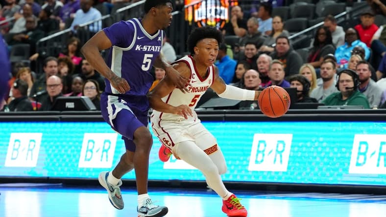 Nov 6, 2023; Las Vegas, Nevada, USA; USC Trojans guard Boogie Ellis (5) dribbles against Kansas State Wildcats guard Cam Carter (5) during the first half at T-Mobile Arena. Mandatory Credit: Stephen R. Sylvanie-USA TODAY Sports