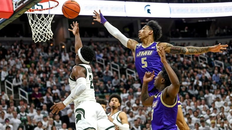 Michigan State's Tyson Walker, left, scores as James Madison's Terrence Edwards, Jr. defends during the second half on Monday, Nov. 6, 2023, in East Lansing.