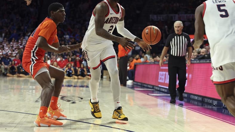 Nov 6, 2023; Tucson, Arizona, USA; Arizona Wildcats guard Caleb Love (2) makes a pass to guard KJ Lewis (5) against Morgan State Bears guard Ahmarie Simpkins (11) during the second half at McKale Center. Mandatory Credit: Zachary BonDurant-USA TODAY Sports