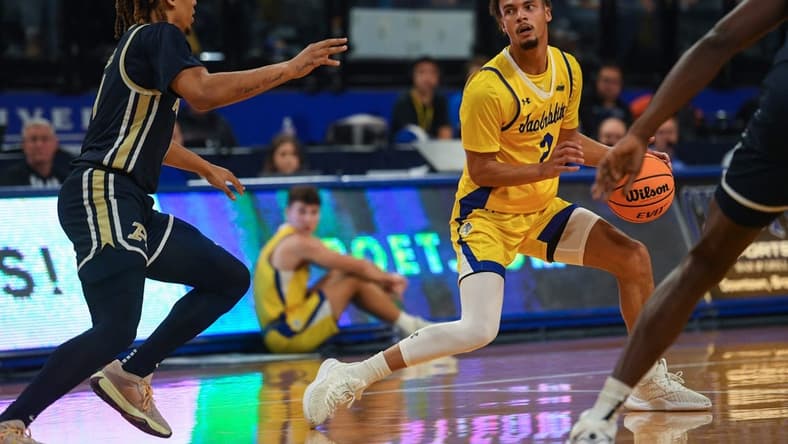 SDSU   s guard Zeke Mayo (2) looks for an opening to pass the ball during a game against Akron on Monday, Nov. 6, 2023 at Frost Arena in Brookings, South Dakota.