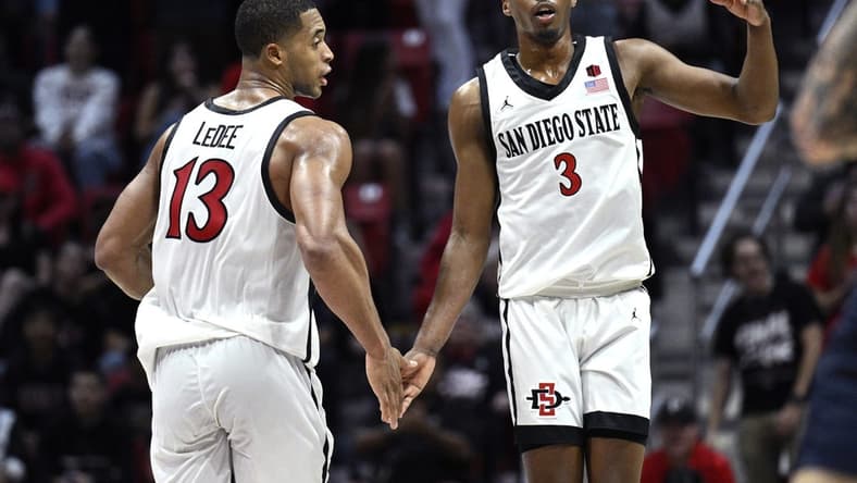 Nov 6, 2023; San Diego, California, USA; San Diego State Aztecs guard Micah Parrish (3) celebrates with forward Jaedon LeDee (13) after a three-point basket against the Cal State Fullerton Titans during the second half at Viejas Arena. Mandatory Credit: Orlando Ramirez-USA TODAY Sports