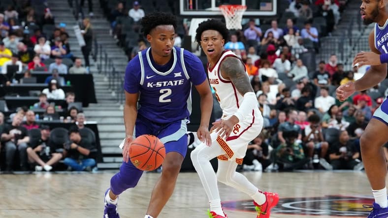 Nov 6, 2023; Las Vegas, Nevada, USA; Kansas State Wildcats guard Tylor Perry (2) dribbles against USC Trojans guard Boogie Ellis (5) during the second half at T-Mobile Arena. Mandatory Credit: Stephen R. Sylvanie-USA TODAY Sports
