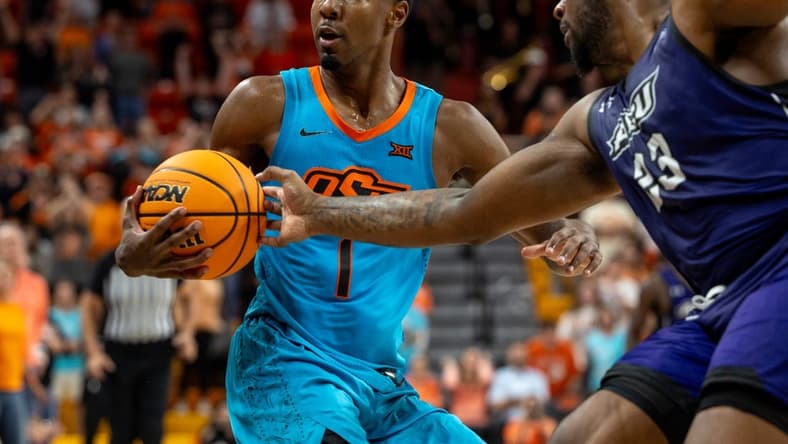 Abilene Christian forward Airion Simmons (23) fouls Oklahoma State guard Bryce Thompson (1) the second half of an NCAA men  s college basketball game Monday, Nov. 6, 2023., in Stillwater, Okla. (Mitch Alcala for the Oklahoman)