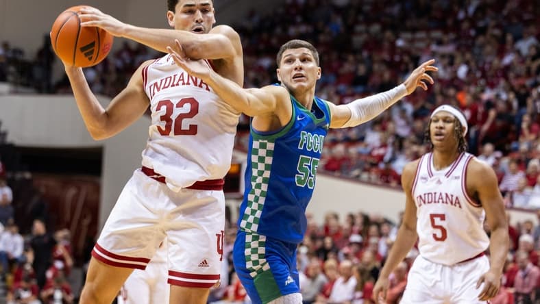 Nov 7, 2023; Bloomington, Indiana, USA; Indiana Hoosiers guard Trey Galloway (32) shoots against Florida Gulf Coast Eagles guard Chase Johnston (55) in the first half at Simon Skjodt Assembly Hall. Mandatory Credit: Trevor Ruszkowski-USA TODAY Sports