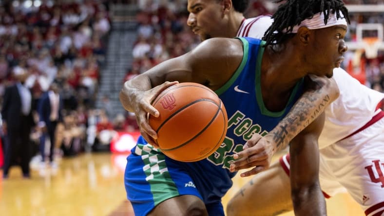 Nov 7, 2023; Bloomington, Indiana, USA; Florida Gulf Coast Eagles forward Keeshawn Kellman (32) dribbles against Indiana Hoosiers center Kel'el Ware (1) in the second half at Simon Skjodt Assembly Hall. Mandatory Credit: Trevor Ruszkowski-USA TODAY Sports