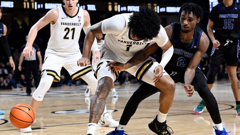 Vanderbilt forward Colin Smith (1) loses control of the ball as Presbyterian guard Samage Teel (2) reaches in during the second half of an NCAA college basketball game Tuesday, Nov. 7, 2023, in Nashville, Tenn. Vanderbilt lost 68-62.