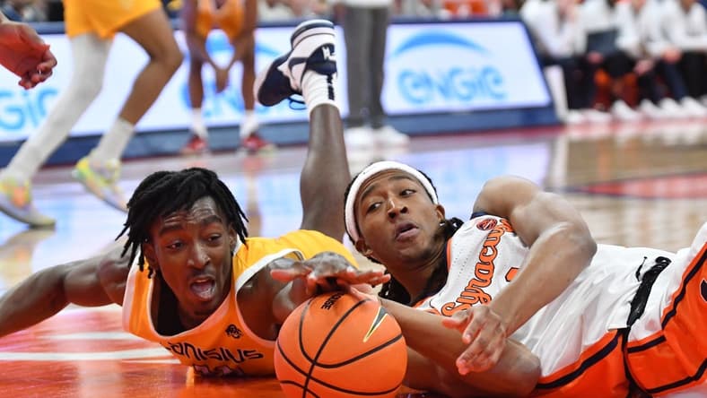 Nov 8, 2023; Syracuse, New York, USA; Canisius Golden Griffins forward Bryce Okpoh (left) and Syracuse Orange forward Maliq Brown reach for a loose ball in the first half at the JMA Wireless Dome. Mandatory Credit: Mark Konezny-USA TODAY Sports