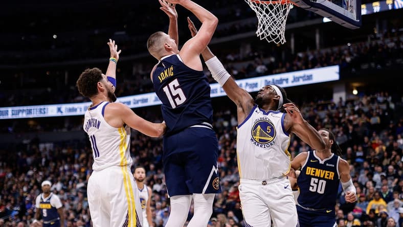 Nov 8, 2023; Denver, Colorado, USA; Denver Nuggets center Nikola Jokic (15) attempts a shot against Golden State Warriors forward Kevon Looney (5) and guard Klay Thompson (11) in the third quarter at Ball Arena. Mandatory Credit: Isaiah J. Downing-USA TODAY Sports