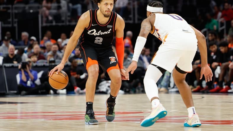 Nov 5, 2023; Detroit, Michigan, USA; Detroit Pistons guard Cade Cunningham (2) dribbles defended by Phoenix Suns guard Jordan Goodwin (0) at Little Caesars Arena. Mandatory Credit: Rick Osentoski-USA TODAY Sports