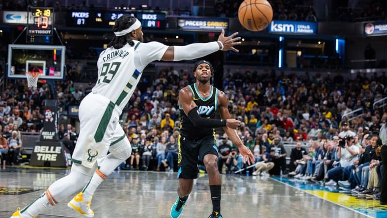 Nov 9, 2023; Indianapolis, Indiana, USA; Indiana Pacers guard Buddy Hield (7) passes the ball while Milwaukee Bucks forward Jae Crowder (99) defends in the second half at Gainbridge Fieldhouse. Mandatory Credit: Trevor Ruszkowski-USA TODAY Sports