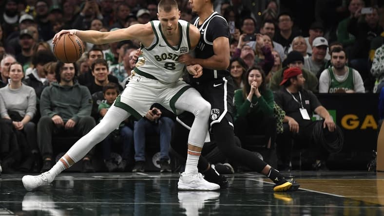 Nov 10, 2023; Boston, Massachusetts, USA; Boston Celtics center Kristaps Porzingis (8) controls the ball while Brooklyn Nets forward Cameron Johnson (2) defends during the first half at TD Garden. Mandatory Credit: Bob DeChiara-USA TODAY Sports