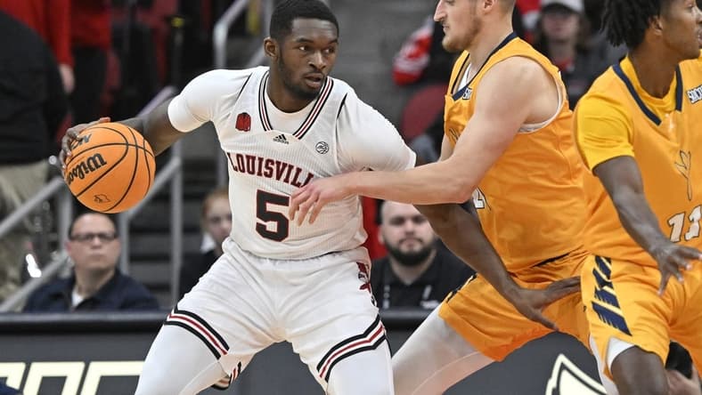 Nov 10, 2023; Louisville, Kentucky, USA; Louisville Cardinals forward Brandon Huntley-Hatfield (5) posts up against Chattanooga Mocs forward Jan Zidek (20) during the first half at KFC Yum! Center. Mandatory Credit: Jamie Rhodes-USA TODAY Sports