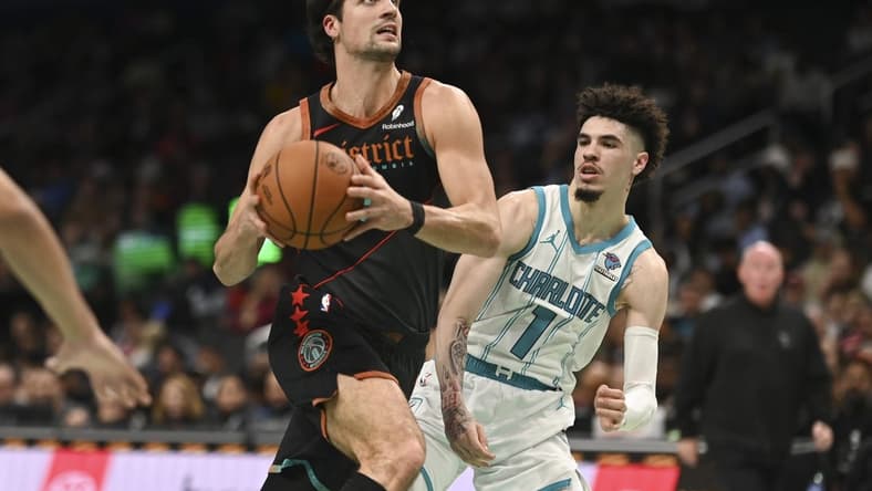 Nov 10, 2023; Washington, District of Columbia, USA; Washington Wizards forward Deni Avdija (8) makes aa move to the basket y Charlotte Hornets guard LaMelo Ball (1) during the first half at Capital One Arena. Mandatory Credit: Tommy Gilligan-USA TODAY Sports